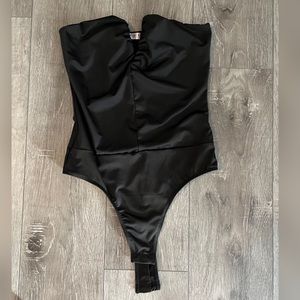 Black strapless body suit. Size medium. Never worn.